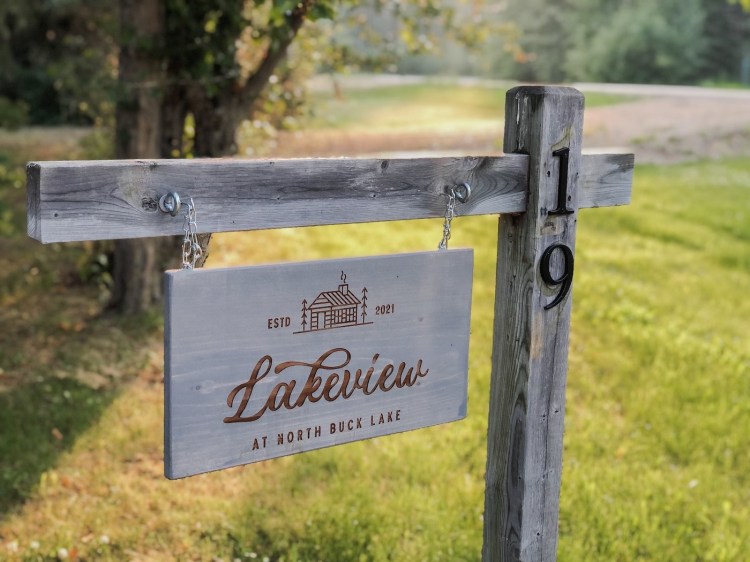 A sign hangs in front of the cottage