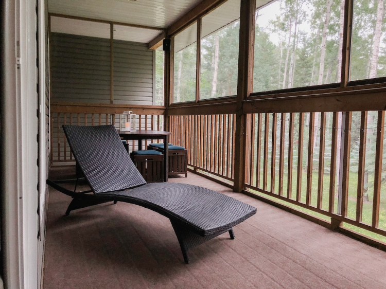The screened in porch overlooking the backyard