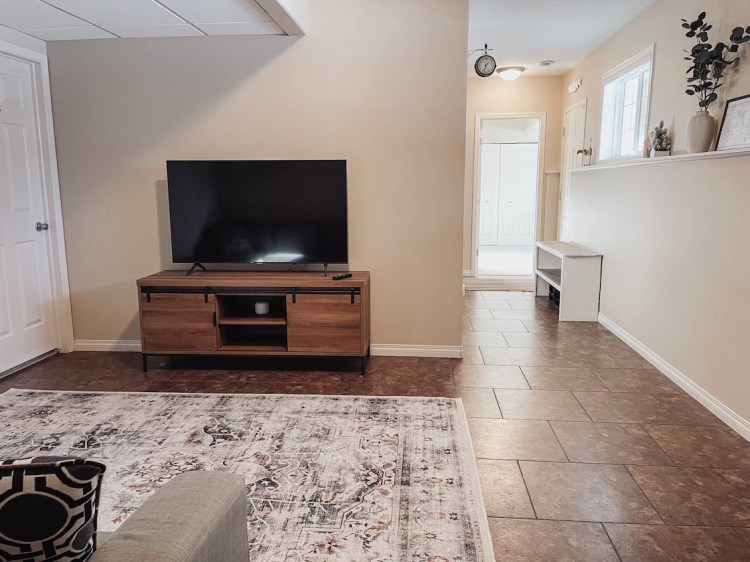 Sun shines through into the basement of a lakefront cottage, into the second living room